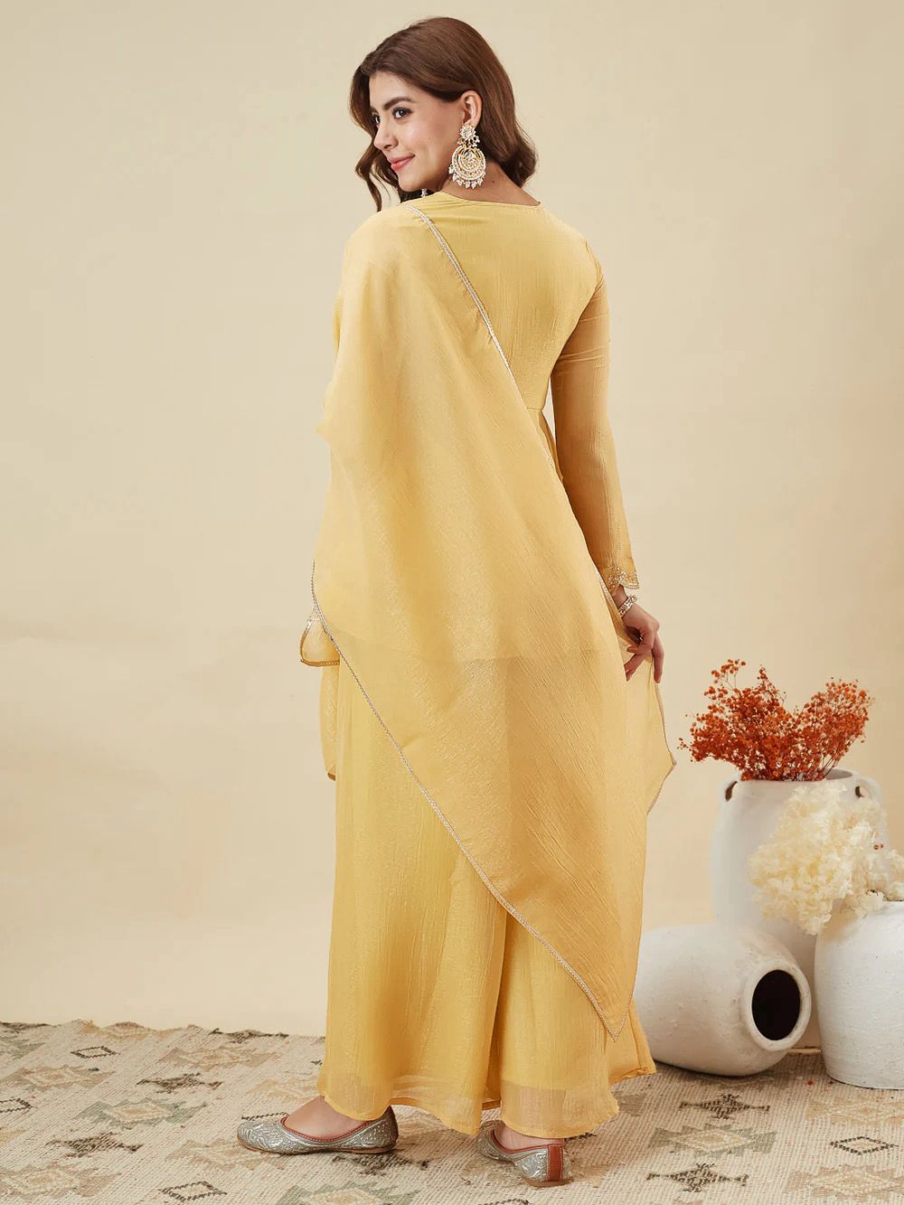 Sunshine Yellow Crunchy Silk Kurta Palazzo Set - studio full length three-quarter standing model view showing complete set profile with A-line kurta, scalloped gold sequence lace hem border, wide-leg palazzo and matching dupatta with thin gold lace trim border flying in the wind