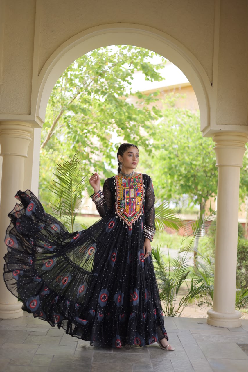 Midnight Black Bandhani Faux Georgette Gown - outdoor haveli archway full length front standing calm pose showing complete gown silhouette with Kutchi patchwork yoke, tiered bandhani body and 12-metre flared skirt