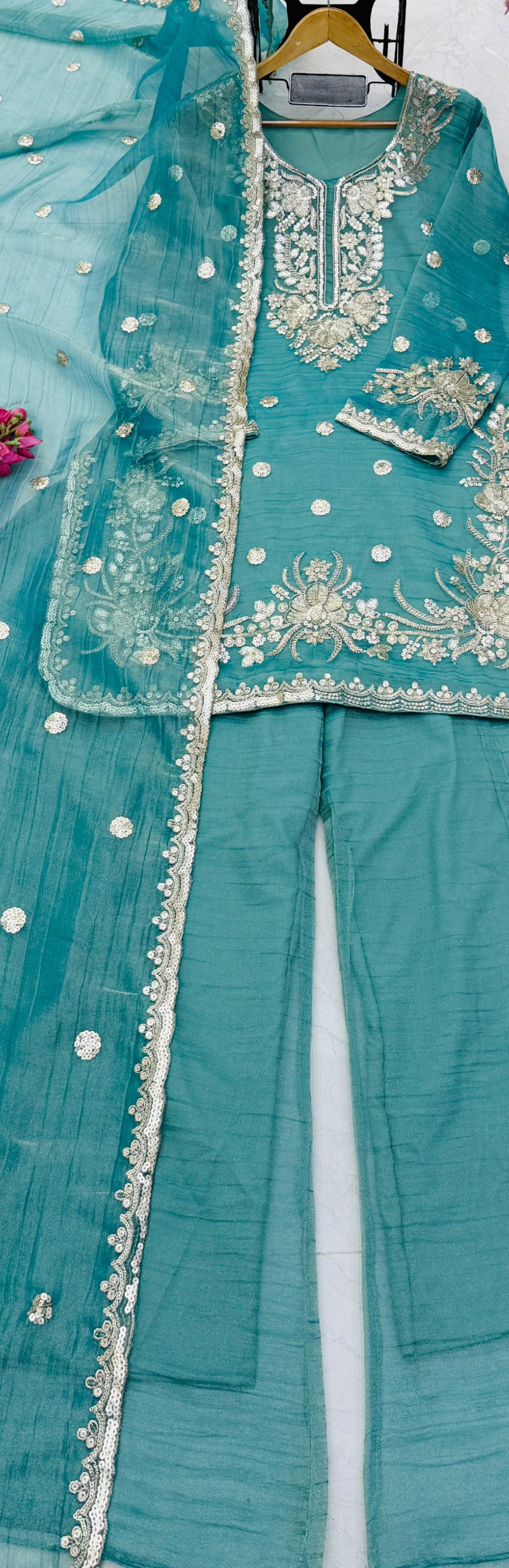 Teal Blue Shalsa Crash Sharara Set - flat lay hanger close-up showing top with dense gold zardozi floral scrollwork yoke embroidery, scattered gold silver sequence circular butti body work, dramatic scalloped gold sequence embroidery hem border, and dupatta with dense scattered silver sequence circular butti and scalloped gold sequence lace border