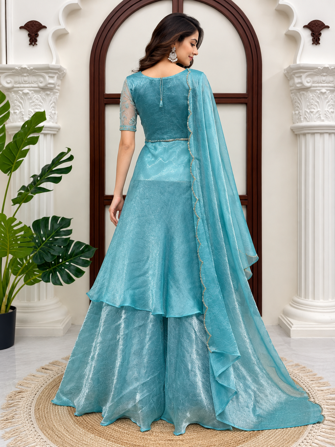 Aqua Blue Fendy Crush Front Slit Anarkali Palazzo Set - heritage interior full length standing model front view showing sweetheart padded blouse with square strap overlay, crystal stone hand-embroidered waist band, sheer net floral sleeves, front-slit skirt with double ruffle cascade hem and aqua blue dupatta with scallop cutwork border