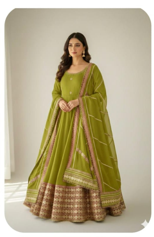 Olive Green Chinon Silk Anarkali Gown Set - studio full length standing model view showing complete 52-54 inch Anarkali gown with all-over coding embroidery, wide gold sequence floral hem border, ruffle dupatta with maroon velvet ribbon edge trim and matching crepe pant