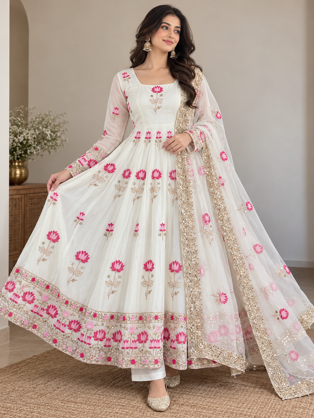 Off-White Fendi Silk Anarkali Gown Set - editorial studio full length motion twirl model view showing spectacular full-flare Anarkali silhouette with all-over hot pink lotus embroidery body, wide multi-row staggered lotus floral hem border revealing dramatic flare, full sheer sleeves and matching net dupatta floating with scattered pink lotus butti and gold sequence border