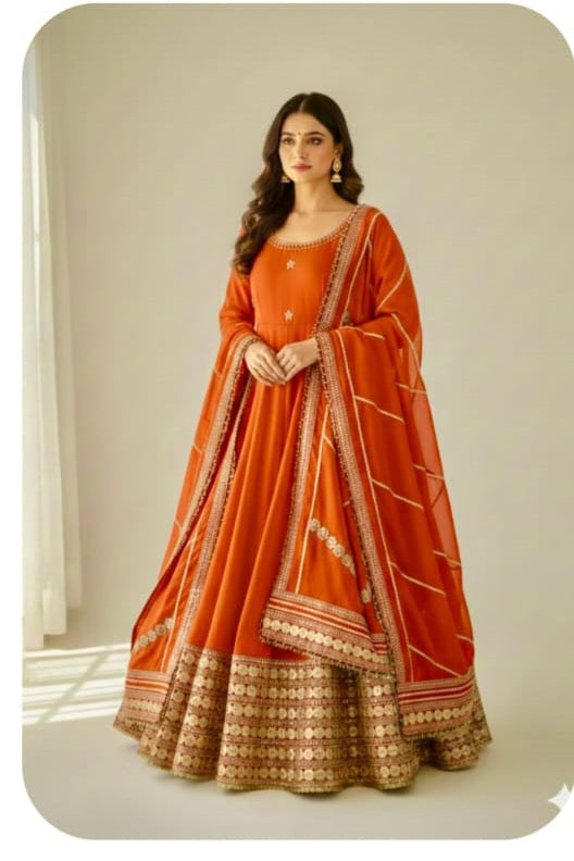 Burnt Orange Rust Chinon Silk Anarkali Gown Set - flat lay product overview showing complete set with gown, matching multi-stripe dupatta with alternating cream gold sequence floral bands and scalloped gold border, and crepe pant with coin lace trim