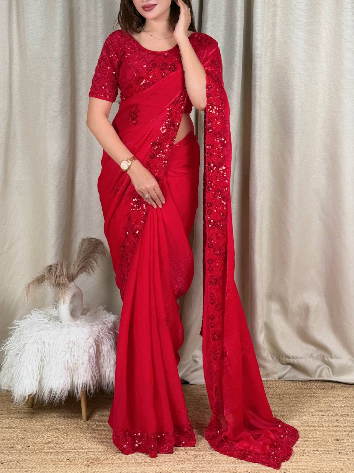 Crimson Red Fandy Satin Saree - flat lay overhead angle showing unstitched crimson fandy satin blouse piece beside folded saree with all-over diamond lattice cord sequence coverage on blouse, 3D raised red sequence floral butti on saree body and scallop cutwork dense sequence floral border clearly visible at saree edge