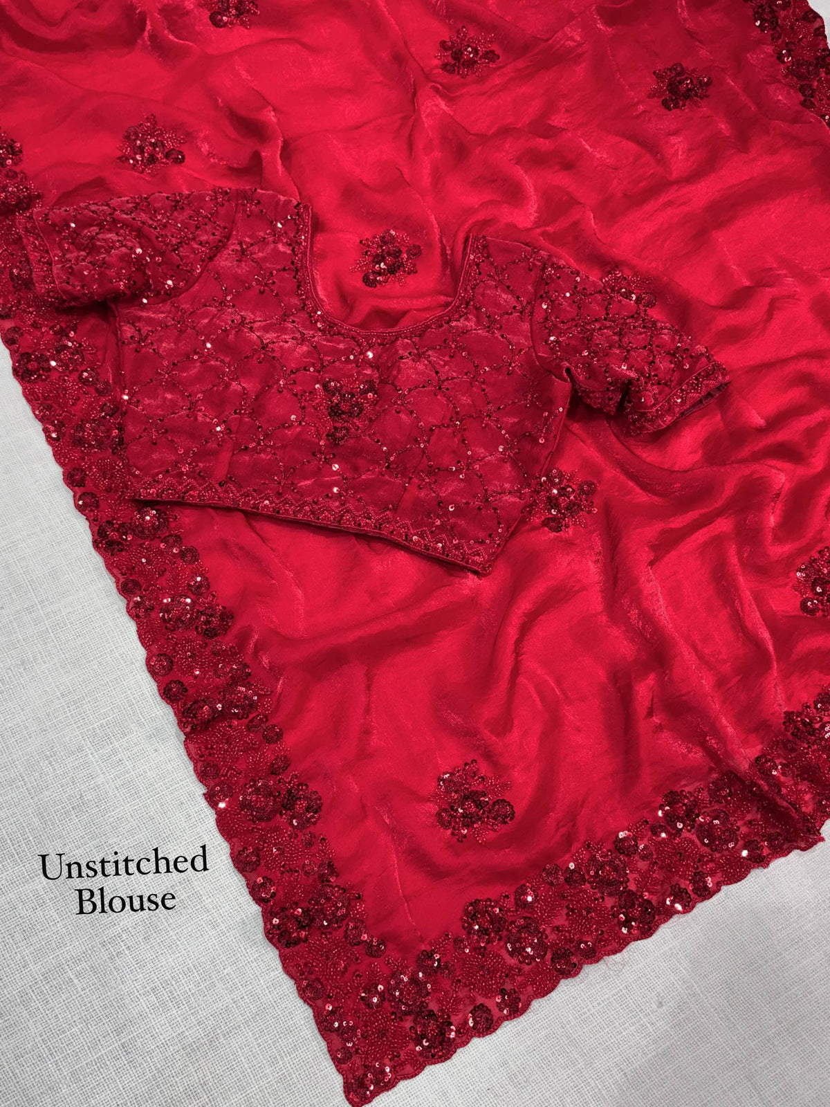 Crimson Red Fandy Satin Saree - flat lay overhead showing complete saree laid out with unstitched blouse piece beside it, showing all-over diamond lattice sequence body with scattered 3D raised red floral butti across saree body, scallop cutwork dense 3D sequence floral border running along saree hem edge