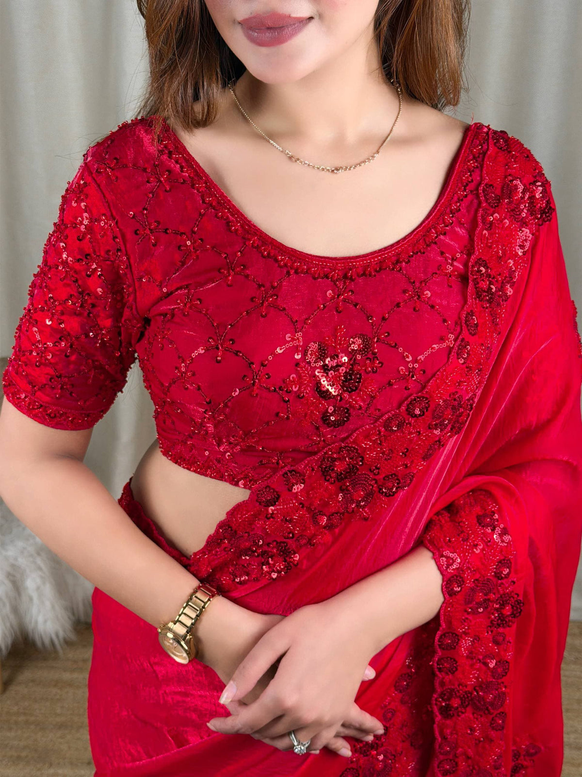Crimson Red Fandy Satin Saree - studio split panel left half-length blouse close-up showing full-coverage tone-on-tone diamond lattice sequence blouse with 3D raised red floral bouquet clusters, right full-length model side view showing complete saree drape with scallop cutwork border at pallu and hem