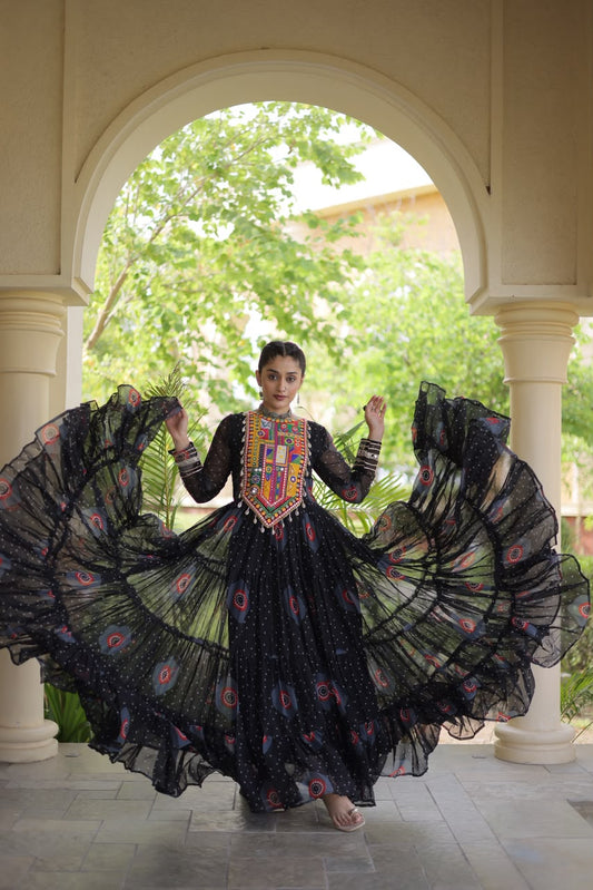 Midnight Black Bandhani Faux Georgette Gown - outdoor haveli archway full length front standing view showing complete 56-inch gown with multicolour Kutchi patchwork yoke, cowrie tassels and gold silver gota lace cuff borders