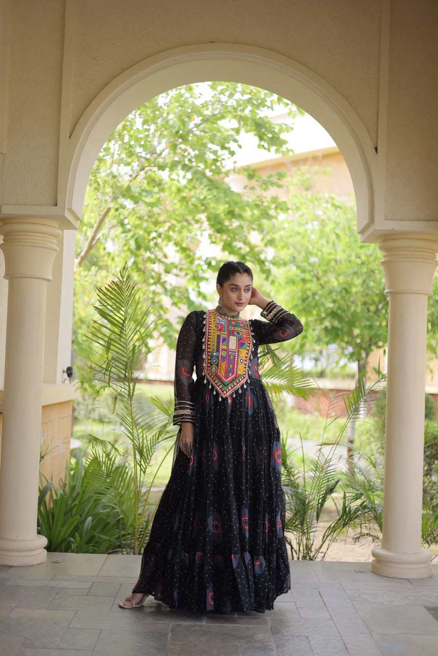 Midnight Black Bandhani Faux Georgette Gown - outdoor haveli archway spectacular full twirl view showing complete 12-metre flair spread wide with bandhani print and circular medallion motifs in full flight