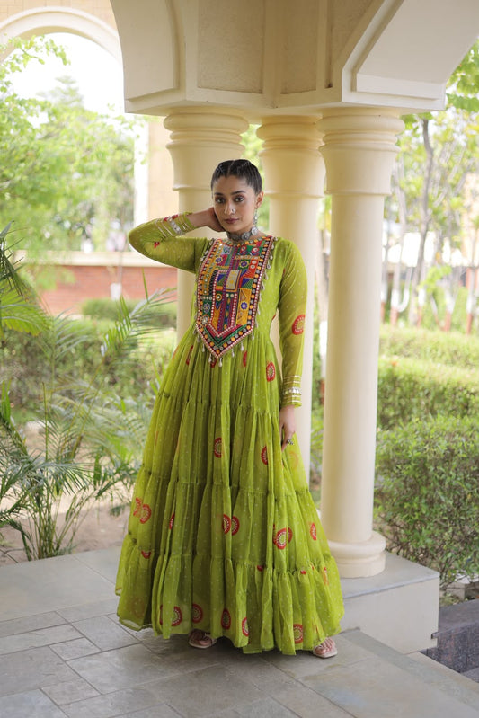 Lime Green Bandhani Faux Georgette Gown - outdoor haveli full length standing view showing complete 56-inch tiered gown with Kutchi patchwork yoke, all-over bandhani dot print with red orange yellow medallion and paisley motifs and 12-metre flair