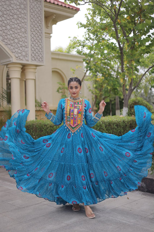 Turquoise Bandhani Faux Georgette Gown - outdoor villa full length front standing view showing complete 56-inch gown with Kutchi patchwork yoke, all-over bandhani dot print with pink purple medallions and 12-metre tiered flair