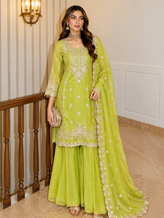 Lime Green Shalsa Crash Sharara Set - grand interior staircase full length standing model view showing complete 3-piece set with gold zardozi yoke embroidery, scattered sequence butti body, scalloped gold sequence floral hem on top and sharara, and matching dupatta with gold sequence lace border