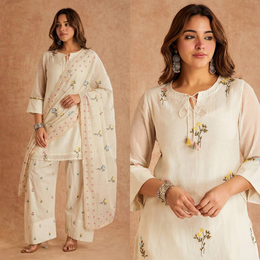 Off-White Cotton Silk Top Farshi Salwar Set - editorial studio full length standing model view showing complete set with round scoop tassel tie neckline, scattered multicolour wildflower butti embroidery on top, 3/4 fluted bell organza sleeves with rainbow embroidery cuff band, farshi salwar with matching scattered wildflower butti embroidery and pink polka dot organza dupatta with pearl lace border draped over arm