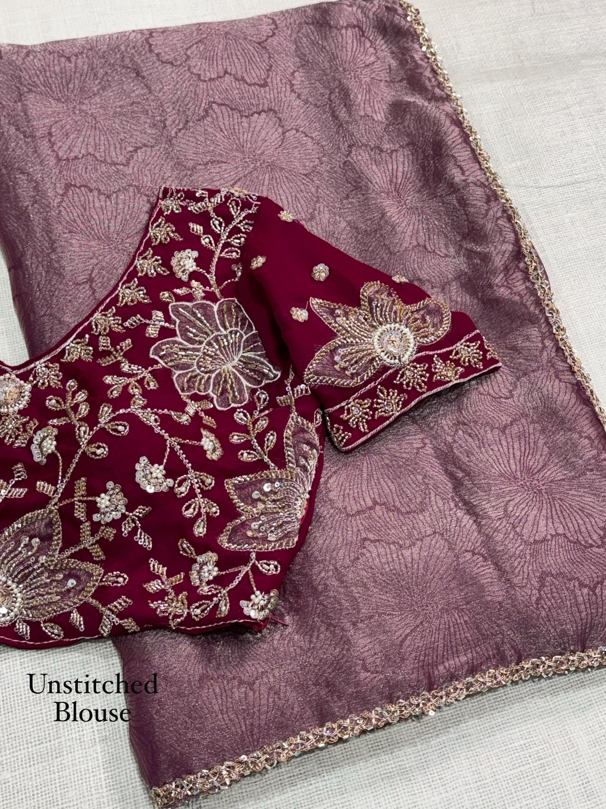 Rose mauve floral jacquard saree with beads lace edging and contrasting wine red beaded applique blouse fabric, labelled unstitched blouse.
