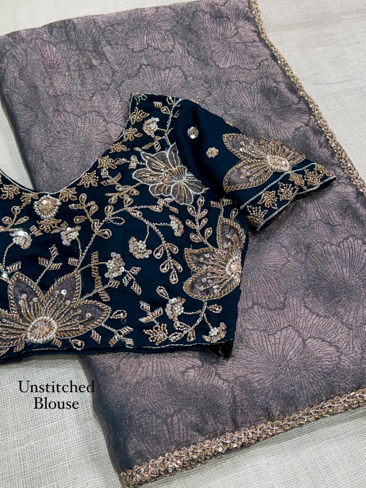 Slate grey floral zari jacquard saree and contrasting navy blue NC moss blouse fabric with beads handwork and grey floral applique, labelled unstitched blouse.