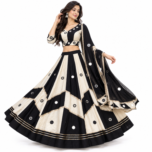 Black White Pali Cotton Chaniya Choli Set studio full length standing model front view showing colour-block blouse with real mirror work, chevron block lehenga with alternating black off-white wedge panels, real circular mirrors, gold sequence lace tier borders, triple gold zari hem band, and black rayon dupatta with mirror butti